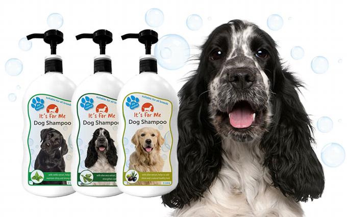 Three bottles of dog shampoo with dog and bubbles behind